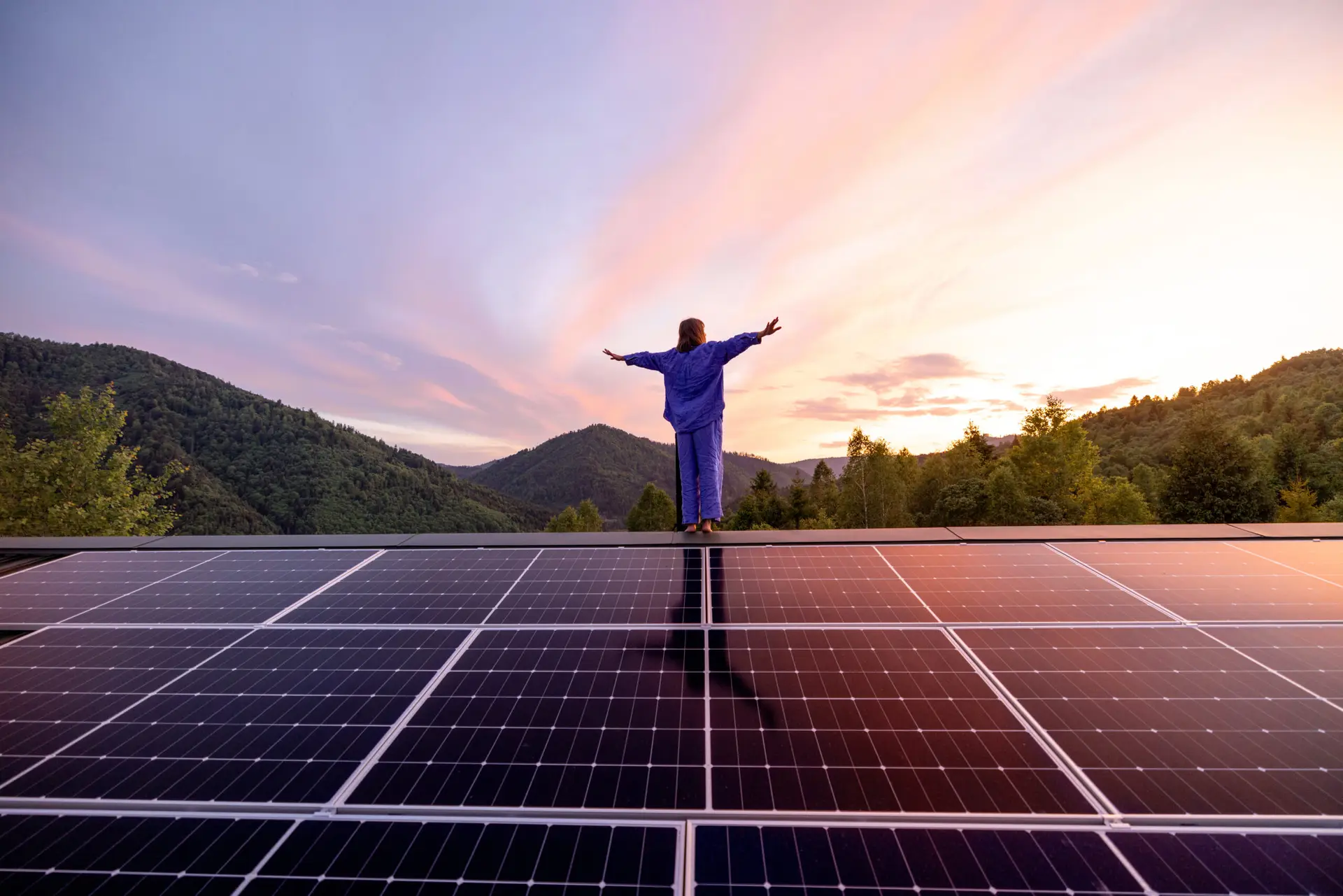 Solarpanels auf einem Hausdach vor Berglandschaft